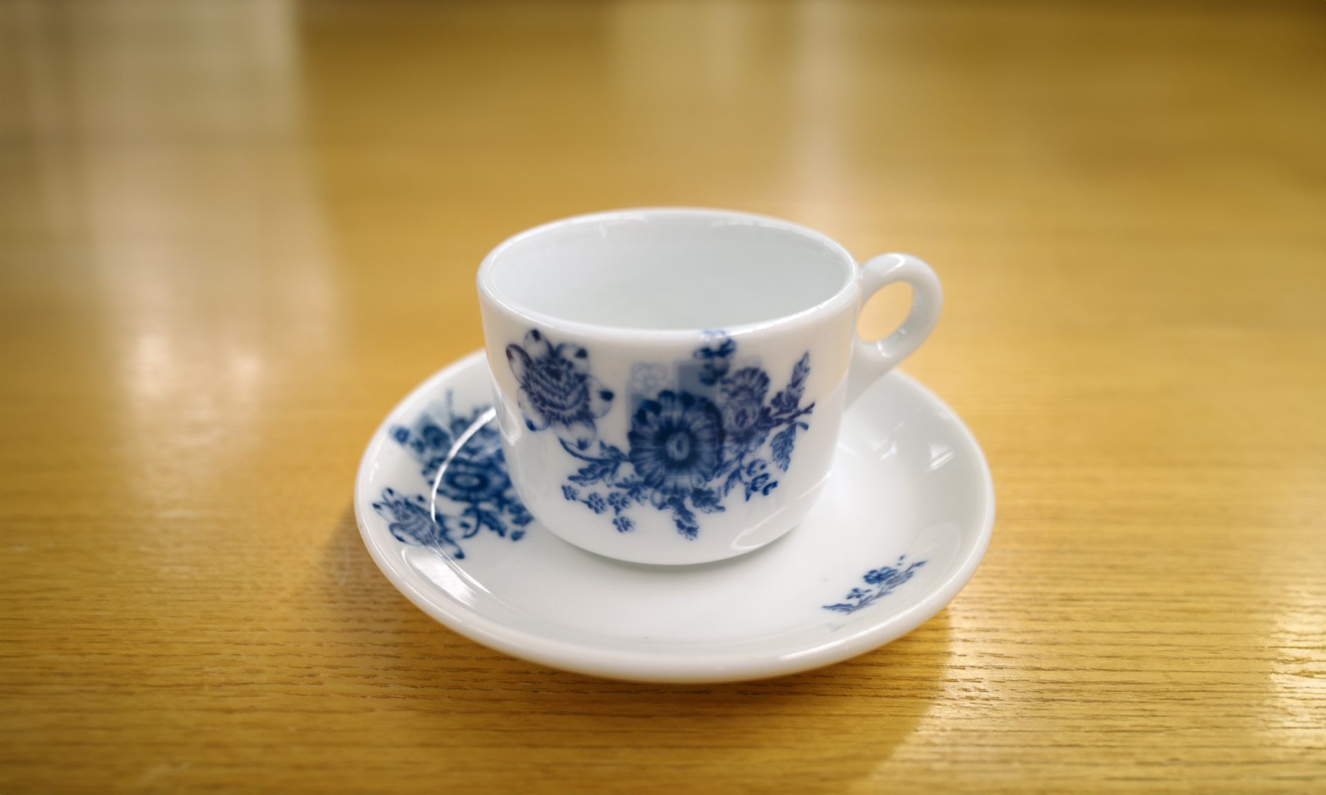 Decorative coffee cup and saucer on a wooden table